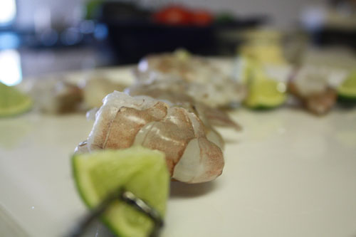 Loading the skewers with shrimp